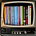 analog television - screen is removed and replaced with several paperback books